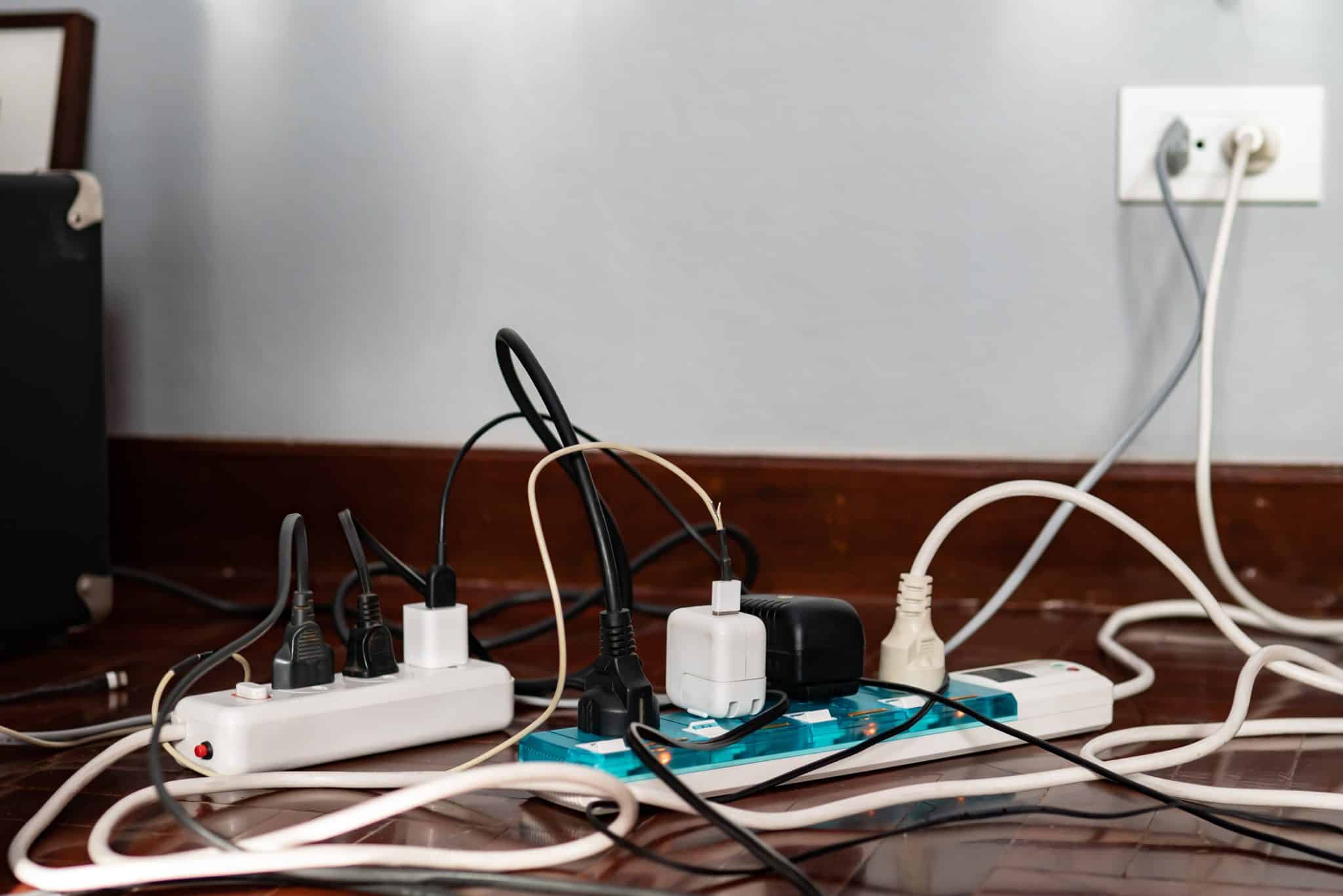 Power strips full of cables and plugs representing energy vampires.