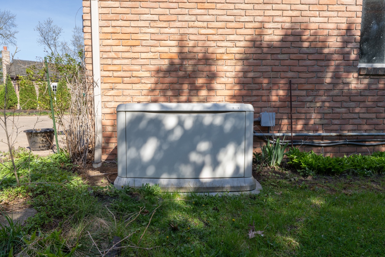 A professionally installed whole-home standby generator on a concrete pad outside a residential home in St. Charles, Missouri.