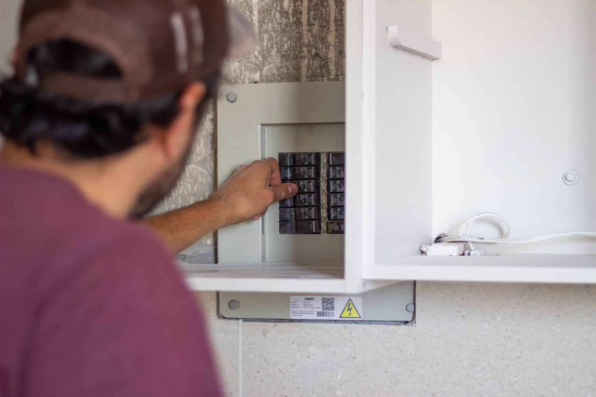 A licensed electrician inspecting an electrical panel during a home electrical inspection in St. Charles, Missouri.